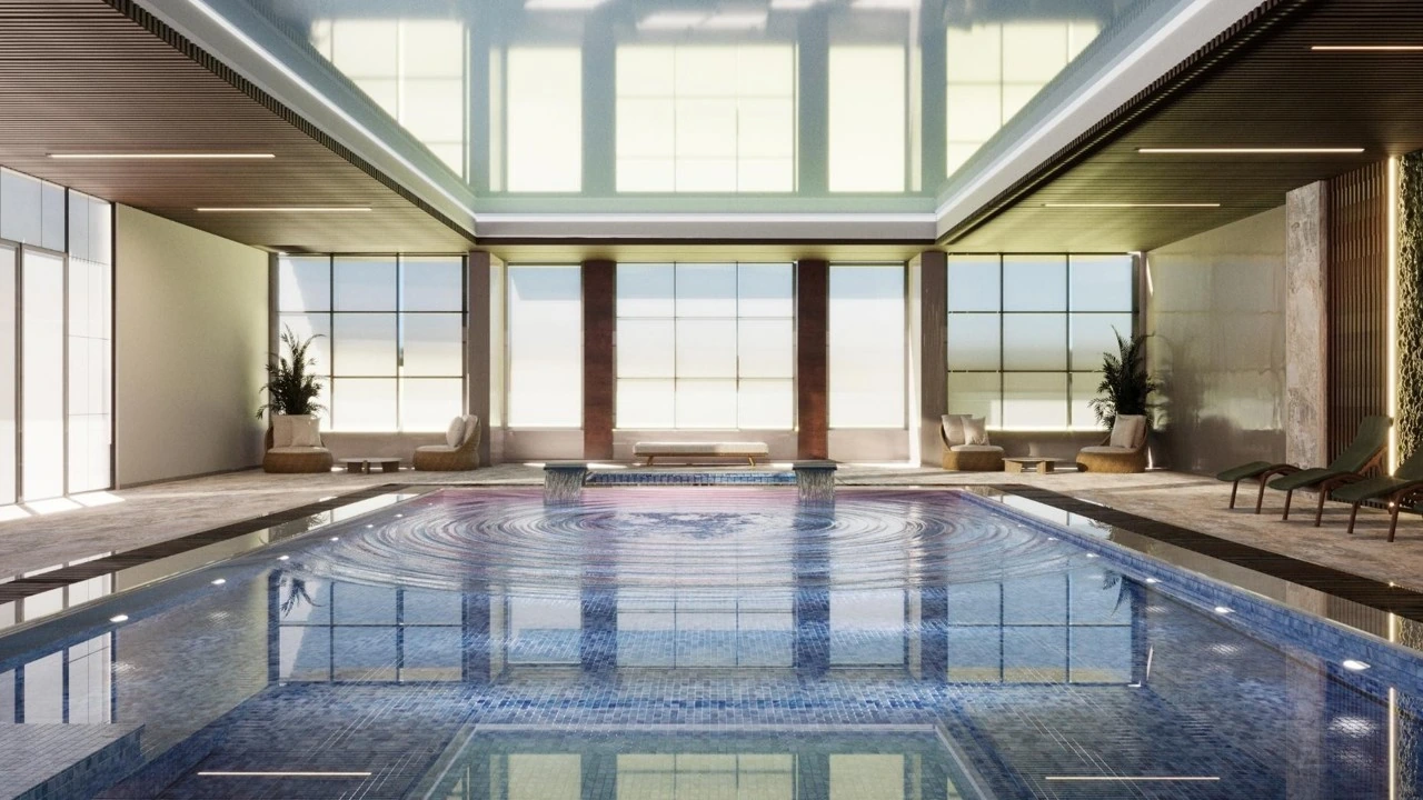 Indoor pool with a glazed roof, natural daylight and poolside lounge seating. Design visualization.